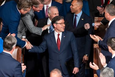 epa11804173 Republican Speaker of the House Mike Johnson (C) greets lawmakers as he re-enters the House chamber after winning the votes to maintain his position as Speaker of the House at the start of the 119th Congress in the US Capitol in Washington, DC, USA, 03 January 2025. The US House of Representatives begins its 119th session with an election for the next Speaker of the House, followed by a swearing-in for all members. EPA/JIM LO SCALZO
