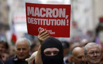 epa11591331 People attend a protest rally in Paris, France, 07 September 2024 as the French left parties called for rallies against President Macron's politics. Protests are taking place across France over the appointment of Michel Barnier as the new French prime minister, after the election that resulted in a National Assembly without a majority and in which the left won the largest number of seats. The poster reads "Macron destitution''.  EPA/YOAN VALAT