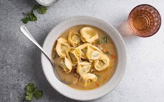 Comfort food, vegetarian meal, soup with pearl barley, tortellini with spinach and ricotta in vegetable stock in bowl viewed from above