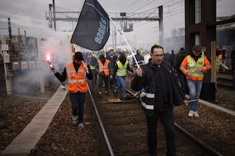epa10546874 Railway workers take part in a demonstration against government pension reform at Lyon train station in Paris, France, 28 March 2023. France faces an ongoing national strike against the government's pensions reform after Prime Minister Elisabeth Borne on 16 March announced the use of article 49 paragraph 3 (49.3) of the Constitution of France to have the text on the controversial pension reform law to be definitively adopted without a vote.  EPA/YOAN VALAT