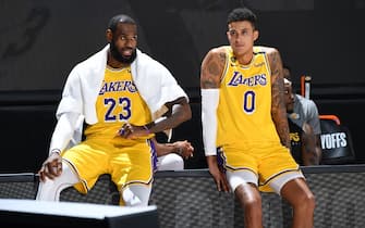 ORLANDO, FL - AUGUST 29: LeBron James #23 and Kyle Kuzma #0 of the Los Angeles Lakers watches the game from the sidelines during Round One, Game Five of the NBA Playoffs on August 29, 2020 at AdventHealth Arena in Orlando, Florida. NOTE TO USER: User expressly acknowledges and agrees that, by downloading and/or using this Photograph, user is consenting to the terms and conditions of the Getty Images License Agreement. Mandatory Copyright Notice: Copyright 2020 NBAE (Photo by Andrew D. Bernstein/NBAE via Getty Images)