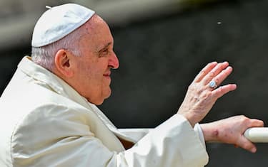 Pope Francis waves from the popemobile car as he leaves at the end of the Palm Sunday mass on April 2, 2023 at St. Peter's square in The Vatican. (Photo by Filippo MONTEFORTE / AFP)