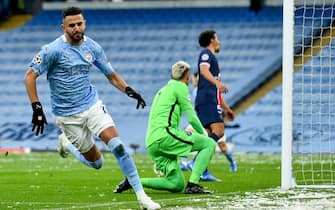 epaselect epa09177827 Manchester City's Riyad Mahrez (L) celebrates after scoring the 1-0 lead during the UEFA Champions League semi final, second leg soccer match between Manchester City and Paris Saint-Germain in Manchester, Britain, 04 May 2021.  EPA/PETER POWELL