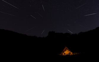 Tourist Tent on a Night Geminids Meteor Shower in a forest 13-14 December 2022 Thailand