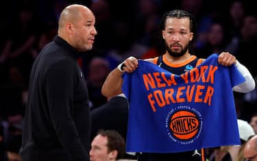 NEW YORK, NEW YORK - APRIL 22: Jalen Brunson #11 of the New York Knicks talks with his father, New York Knicks assistant coach Rick Brunson, during the second half against the Philadelphia 76ers in Game Two of the Eastern Conference First Round Playoffs at Madison Square Garden on April 22, 2024 in New York City. The Knicks won 104-101. NOTE TO USER: User expressly acknowledges and agrees that, by downloading and or using this photograph, User is consenting to the terms and conditions of the Getty Images License Agreement. (Photo by Sarah Stier/Getty Images)