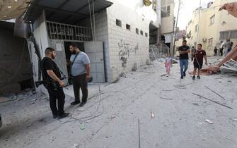 epa10932242 Palestinians inspect the damages following an Israeli airstrike at Al-Ansar Mosque at Jenin refugee camp on 22 October 2023. At least two people were killed in an early morning Israeli forces airstrike on Al Ansar mosque in Jenin, according to Palestinian Health Ministry. The Israeli Defense Forces said the airstrike was targeting the Hamas and Islamic Jihad terrorist compound in the Al-Ansar Mosque in Jenin.  EPA/ALAA BADARNEH