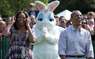 WASHINGTON, DC - APRIL 21:  U.S. President Barack Obama (R) and first lady Michelle Obama (L) rejoice as they watch children participate in the annual White House Easter Egg Roll on the South Lawn April 21, 2014 in Washington, DC. President Obama and the first lady hosted thousands of children for the annual White House event dating back to 1876 that features live music, sports courts, cooking stations, storytelling, as well as the Easter egg roll this year.  (Photo by Alex Wong/Getty Images)