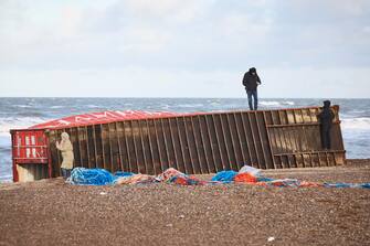 epa11044610 Locals inspect items from containers spillage  along the West coast at Tranum beach in North Jutland, Denmark, 26 December 2023. The contents of 46 lost containers from the ship Mayview Maersk wash ashore in North Jutland. The containers washed overboard during storm Pia.  EPA/Claus Bjoern Larsen  DENMARK OUT