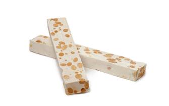 Bars of Nougat with almonds and pistachio nuts on white background
