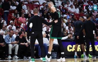MIAMI, FLORIDA - APRIL 29: Kristaps Porzingis #8 of the Boston Celtics leaves the game against the Miami Heat during the second quarter after suffering an apparent injury in game four of the Eastern Conference First Round Playoffs at Kaseya Center on April 29, 2024 in Miami, Florida.  NOTE TO USER: User expressly acknowledges and agrees that, by downloading and or using this photograph, User is consenting to the terms and conditions of the Getty Images License Agreement. (Photo by Megan Briggs/Getty Images)