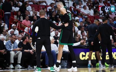 MIAMI, FLORIDA - APRIL 29: Kristaps Porzingis #8 of the Boston Celtics leaves the game against the Miami Heat during the second quarter after suffering an apparent injury in game four of the Eastern Conference First Round Playoffs at Kaseya Center on April 29, 2024 in Miami, Florida.  NOTE TO USER: User expressly acknowledges and agrees that, by downloading and or using this photograph, User is consenting to the terms and conditions of the Getty Images License Agreement. (Photo by Megan Briggs/Getty Images)