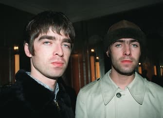 Brothers Liam (right) and Noel Gallagher, singer and guitarist respectively from the band Oasis, who are performing at a secret location in London for their loyal fans. 2/3/99: Settle royalties dispute out of court with ex-drummer Tony McCarroll.   (Photo by PA Images via Getty Images)