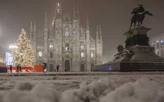 Milan Cathedral and monument night, in winter with snow