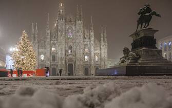 Milan Cathedral and monument night, in winter with snow