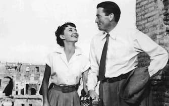Belgian-born actor Audrey Hepburn (1929-1993) holds the hand of American actor Gregory Peck in a still from the film 'Roman Holiday,' directed by William Wyler, 1953. Actor Gregory Peck died June 12, 2003 at age 87 of natural causes in his Los Angeles, California home. (Photo by Paramount Pictures/Courtesy of Getty Images)