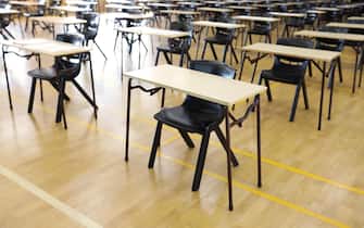 various views of an exam examination room or hall set up ready for students to sit test. multiple desks tables and chairs. Education, school, student