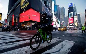 NEW YORK, NEW YORK - FEBRUARY 21: A man rides an e-bike through Times Square on February 21, 2023 in New York City. New York City Fire Commissioner Laura Kavanagh has called upon the Consumer Product Safety Commission to take action and help prevent what it calls sub-standard lithium-ion batteries after NYC experienced hundreds of e-bike and e-scooter battery fires. (Photo by Leonardo Munoz/VIEWpress via Getty Images)
