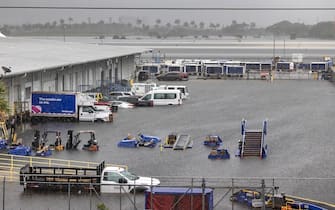 epa10571678 Airport vehicles are stranded at the Fort Lauderdale International Airport in Fort Lauderdale, Florida, USA, 13 April 2023. Heavy rains in the past days produced flooding in the lower areas of the Miami-Dade and Broward counties.  EPA/CRISTOBAL HERRERA-ULASHKEVICH