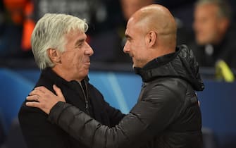 Atalanta's Italian head coach Gian Piero Gasperini (L) is greeted by Manchester City's Spanish manager Pep Guardiola (R) during the UEFA Champions League Group C football match between Manchester City and Atalanta at the Etihad Stadium in Manchester, northwest England on October 22, 2019. (Photo by Oli SCARFF / AFP) (Photo by OLI SCARFF/AFP via Getty Images)