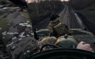 AVDIIVKA DISTRIKT, UKRAINE - FEBRUARY 14: Soldiers on the Armored Infantry Vehicle 2 (BMP-2) on the road to the city, the outskirts of Avdiivka on February 14, 2024 in Avdiivka district, Ukraine. Both Ukraine and Russia have recently claimed gains in the Avdiivka, where Russia is continuing a long-running campaign to capture the city, located in the Ukraine's eastern Donetsk Region. Last week, the Russian army was successful in advancing towards the city and captured the main supply road. (Photo by Vlada Liberova/Libkos/Getty Images)
