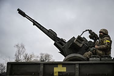 An Ukrainian soldier keeps position sitting on a ZU-23-2 anti-aircraft gun at a frontline, northeast of Kyiv on March 3, 2022. - A Ukrainian negotiator headed for ceasefire talks with Russia said on March 3, 2022, that his objective was securing humanitarian corridors, as Russian troops advance one week into their invasion  of the Ukraine. (Photo by Aris Messinis / AFP) (Photo by ARIS MESSINIS/AFP via Getty Images)