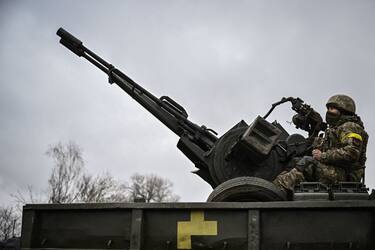 An Ukrainian soldier keeps position sitting on a ZU-23-2 anti-aircraft gun at a frontline, northeast of Kyiv on March 3, 2022. - A Ukrainian negotiator headed for ceasefire talks with Russia said on March 3, 2022, that his objective was securing humanitarian corridors, as Russian troops advance one week into their invasion  of the Ukraine. (Photo by Aris Messinis / AFP) (Photo by ARIS MESSINIS/AFP via Getty Images)