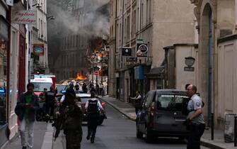 Smoke billows from rubbles of a building at Place Alphonse-Laveran in the 5th arrondissement of Paris, on June 21, 2023. A major fire of unknown origin broke out on June 21, 2023 in a building in central Paris, part of which collapsed, injuring at least one person, according to sources and AFP images. (Photo by ABDULMONAM EASSA / AFP) (Photo by ABDULMONAM EASSA/AFP via Getty Images)