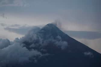 epa10681200 Mayon Volcano emits steam as seen from  Legazpi city, Albay province, Philippines, 09 June 2023. More than 20,000 residents living around Mayon volcano's danger zone are being evacuated in schools, gymnasiums, and tents amid impending eruption.  EPA/FRANCIS R. MALASIG