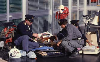 ROME, ITALY, DECEMBER 27, 1985 - Fiumicino Airport (Rome). On 12/27/1985 the Palestinian terroristic group Abu Nidal assaulted simultaneously the airports of Rome and Vienna. Around 9.15 AM, 4 terrorists opened fire with machine gun bursts on passengers queuing for baggage check-in at the counters of the Israeli national airline El Al and the American TWA at Roma-Fiumicino airport. In the attack, 13 people were killed and 76 wounded, 3 of the Palestinian terrorists were killed by Israeli security agents and the commando leader Mohammed Sharam was captured alive by the Italian police. A few minutes after the attack in Italy, the attack in Vienna airport broke out, causing 3 deaths and 44 injuries. In this picture the Italian police investigating. (Photo by Edoardo Fornaciari/Getty Images)