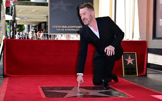 US actor Macaulay Culkin gestures near his newly unveiled Hollywood Walk of Fame Star in Hollywood, California, on December 1, 2023. (Photo by Frederic J. BROWN / AFP)