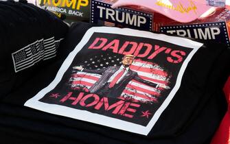 Tee shirts, hats and memorabilia supporter US President Donald Trump is for sale by a vendor who regularly sets up a street stand next to Donald Trump's star on the Hollywood Walk of Fame on January 20, 2025 as Trump's inauguration as the 47th US president. (Photo by Robyn Beck / AFP)
