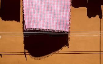 VENICE, ITALY- JUNE 11:  Clothes hang drying on a washing line, casting a shadow on the wall in Venice on June 11, 2009 in Venice, Italy. (Photo by Massimo Di Nonno/Getty Images)