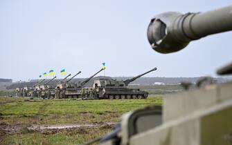 SOUTH WEST, ENGLAND - MARCH 24: AS90 155mm self-propelled guns with Ukrainian flags are seen during final training, on March 24, 2023 in South West, England. Ukrainian artillery recruits come to the end of their training on AS90 155mm self-propelled gun. Ukrainian personnel have been live-firing the guns for the first time, under the supervision of their British Army instructors, at a British Army training facility. Training on the AS90 is happening at a specialist facility under the control of the Royal School of Artillery and is conducted by officers and soldiers of the Royal Regiment of Artillery. The program is part of the UK's enduring commitment to support Ukraine in its fight against Russia's unprovoked invasion. (Photo by Finnbarr Webster/Getty Images) (Photo by Finnbarr Webster/Getty Images)