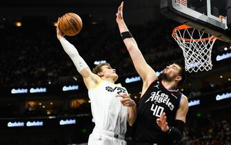 SALT LAKE CITY, UTAH - JANUARY 18: Lauri Markkanen #23 of the Utah Jazz dunks over Ivica Zubac #40 of the LA Clippers during the second half of a game at Vivint Arena on January 18, 2023 in Salt Lake City, Utah. NOTE TO USER: User expressly acknowledges and agrees that, by downloading and or using this photograph, User is consenting to the terms and conditions of the Getty Images License Agreement.  (Photo by Alex Goodlett/Getty Images)