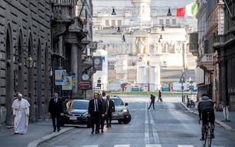 ROME, ITALY - MARCH 15: (EDITORIAL USE ONLY – STRICTLY NO COMMERCIAL OR MERCHANDISING USAGE) Pope Francis walks in a desert (due to Coronavirus emergency) Via Del Corso, as he leaves the church of San Marcello on the Corso, where a miraculous crucifix is housed on March 15, 2020 in Rome, Italy. Pope Francis left the Vatican on Sunday to visit, on the Third Sunday of Lent, two important pilgrimage sites in Rome to pray for the city and the world, in the midst of the Covid-19 coronavirus outbreak. Photo by Vatican Pool/Vatican Media via Vatican Pool/Getty Images)