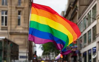 epa08527335 People wave rainbow flags during a pride march in Paris, France, 04 July 2020. The march took place to bring attention to LGBTQ causes, although it is not the official Gay Pride march - initially due to take place 27 June but was postponed to 07 November 2020.  EPA/IAN LANGSDON