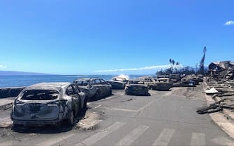 Burned cars and destroyed buildings are pictured in the aftermath of a wildfire in Lahaina, western Maui, Hawaii on August 11, 2023. A wildfire that left Lahaina in charred ruins has killed at least 55 people, authorities said on August 10, making it one of the deadliest disasters in the US state's history. Brushfires on Maui, fueled by high winds from Hurricane Dora passing to the south of Hawaii, broke out August 8 and rapidly engulfed Lahaina. (Photo by Paula RAMON / AFP) / "The erroneous mention[s] appearing in the metadata of this photo by Paula RAMON has been modified in AFP systems in the following manner: [August 11] instead of [August 10]. Please immediately remove the erroneous mention[s] from all your online services and delete it (them) from your servers. If you have been authorized by AFP to distribute it (them) to third parties, please ensure that the same actions are carried out by them. Failure to promptly comply with these instructions will entail liability on your part for any continued or post notification usage. Therefore we thank you very much for all your attention and prompt action. We are sorry for the inconvenience this notification may cause and remain at your disposal for any further information you may require." (Photo by PAULA RAMON/AFP via Getty Images)