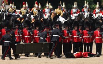 A member of the Grenadier Guards faints during the Colonel's Review at Horse Guards Parade in London on June 10, 2023 ahead of The King's Birthday Parade. The Colonel's Review is the final evaluation of the parade before it goes before Britain's King Charles III during the Trooping of the Colour on June 17. (Photo by Adrian DENNIS / AFP) (Photo by ADRIAN DENNIS/AFP via Getty Images)