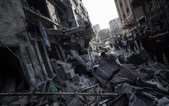 GAZA CITY, GAZA - OCTOBER 31: People search for usable items among the debris of destroyed buildings as Israeli attacks continue at Al-Shati refugee camp of Gaza City, Gaza on October 31, 2023. (Photo by Ali Jadallah/Anadolu via Getty Images)