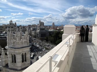 Tourists looking at the city of Madrid from the lookout tower at the Palacio de Cibeles, Madrid City Hall, Spain, March 2011. (Photo by Cristina Arias/Cover/Getty Images)