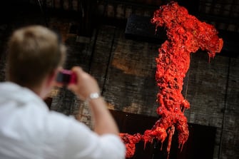 A visitor looks at a piece by Italian artist Gaetano Pesce during the 54th International Art Exhibition in Venice on June 1, 2011. The Biennale  entitled Illuminazioni that will open to the public from June 4th to November 27th  2011, in the Giardini and the Arsenale exhibition venues, as well as in various other locations around the city. AFP PHOTO / Filippo MONTEFORTE (Photo credit should read FILIPPO MONTEFORTE/AFP via Getty Images)