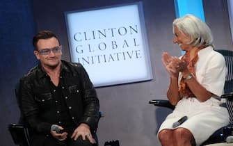 Bono, lead singer U2 and Christine Lagarde, Managing Director, International Monetary Fund attend the Clinton Global Initiative (CGI) on September 24, 2013 in New York. AFP PHOTO/Mehdi Taamallah        (Photo credit should read MEHDI TAAMALLAH/AFP via Getty Images)