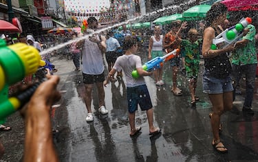 People take part in a water gun battle as part of the annual Songkran festival, also known as water festival, at the tourist spot of Khao San Road in Bangkok, Thailand, 13 April 2023. (Photo by Anusak Laowilas/NurPhoto via Getty Images)