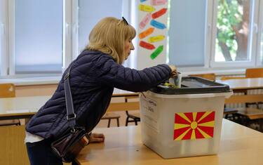 epa11297110 A woman casts her vote during the first round of the presidential elections, at a polling station in Skopje, North Macedonia, 24 April 2024. More than 1.8 million registered voters are expected to choose between seven presidential candidates running for the largely ceremonial position in the first round of the country's presidential election held on 24 April.  EPA/GEORGI LICOVSKI