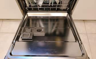 Close-up of an open dishwasher door, with an open and empty detergent door and dishes visible in the rack beyond, photographed in Lafayette, California, April 5, 2021. (Photo by Smith Collection/Gado/Getty Images)