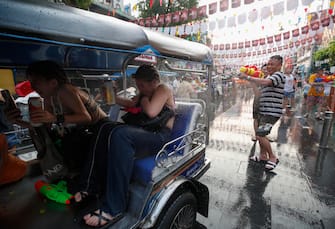 epa10569553 Foreign tourists traveling on a Tuk Tuk taxi are doused with water during the annual Songkran festival, the Thai traditional New Year celebrations also known as the water festival at the tourist spot Khao San road in Bangkok, Thailand, 12 April 2023. Thailand celebrates the most lively Songkran festival after a three-year pause by the COVID-19 coronavirus pandemic. Songkran festival, the Thai traditional New Year, annually falls on 13 April, Songkran also known as the water festival, is celebrated with splashing water and putting powder on each other's faces as a symbolic sign of cleansing and washing away the sins from the old year.  EPA/RUNGROJ YONGRIT