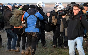 17 January 2023, North Rhine-Westphalia, Erkelenz: Police officers carry Swedish climate activist Greta Thunberg (M) out of a group of protesters and activists and away from the edge of the Garzweiler II opencast lignite mine. Activists and coal opponents continue their protests at several locations in North Rhine-Westphalia on Tuesday. Photo: Federico Gambarini/dpa (Photo by Federico Gambarini/picture alliance via Getty Images)