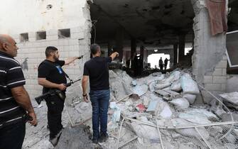 epa10932241 Palestinians inspect the damages following an Israeli airstrike at Al-Ansar Mosque at Jenin refugee camp on 22 October 2023. At least two people were killed in an early morning Israeli forces airstrike on Al Ansar mosque in Jenin, according to Palestinian Health Ministry. The Israeli Defense Forces said the airstrike was targeting the Hamas and Islamic Jihad terrorist compound in the Al-Ansar Mosque in Jenin.  EPA/ALAA BADARNEH