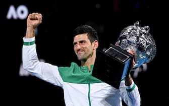 epa09668648 (FILE) Novak Djokovic of Serbia lifts the Norman Brooks Challenge Cup after winning his Men's singles finals match against Daniil Medvedev of Russia on Day 14 of the Australian Open Grand Slam tennis tournament at Melbourne Park in Melbourne, Australia, 21 February 2021 (re-isssued 05 January 2022).  Novak Djokovic was denied entry to Australia after his visa was refused amid a vaccine exemption row.  EPA/DAVE HUNT AUSTRALIA AND NEW ZEALAND OUT *** Local Caption *** 56713640