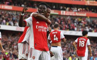 epa09489977 Bukayo Saka (front) of Arsenal celebrates after scoring the 3-0 during the English Premier League soccer match between Arsenal FC and Tottenham Hotspur in London, Britain, 26 September 2021.  EPA/Facundo Arrizabalaga EDITORIAL USE ONLY. No use with unauthorized audio, video, data, fixture lists, club/league logos or 'live' services. Online in-match use limited to 120 images, no video emulation. No use in betting, games or single club/league/player publications
